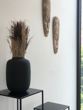 Magnifique bouquet de fleurs séchées dans des tons naturel et brun posé sur un duo de tables d'appoint en métal noir.